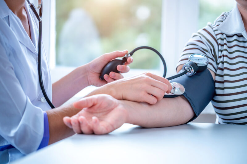 Doctor measures the pressure of the patient during a medical exa